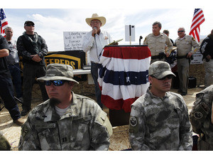 Rancher Cliven Bundy, middle, addresses his supporters along side Clark County Sheriff Doug Gillespie, right, on April 12, 2014. Bundy informed the public that the BLM has agreed to cease the roundup of his family's cattle.(AP Photo/Las Vegas Review-Journal, Jason Bean)